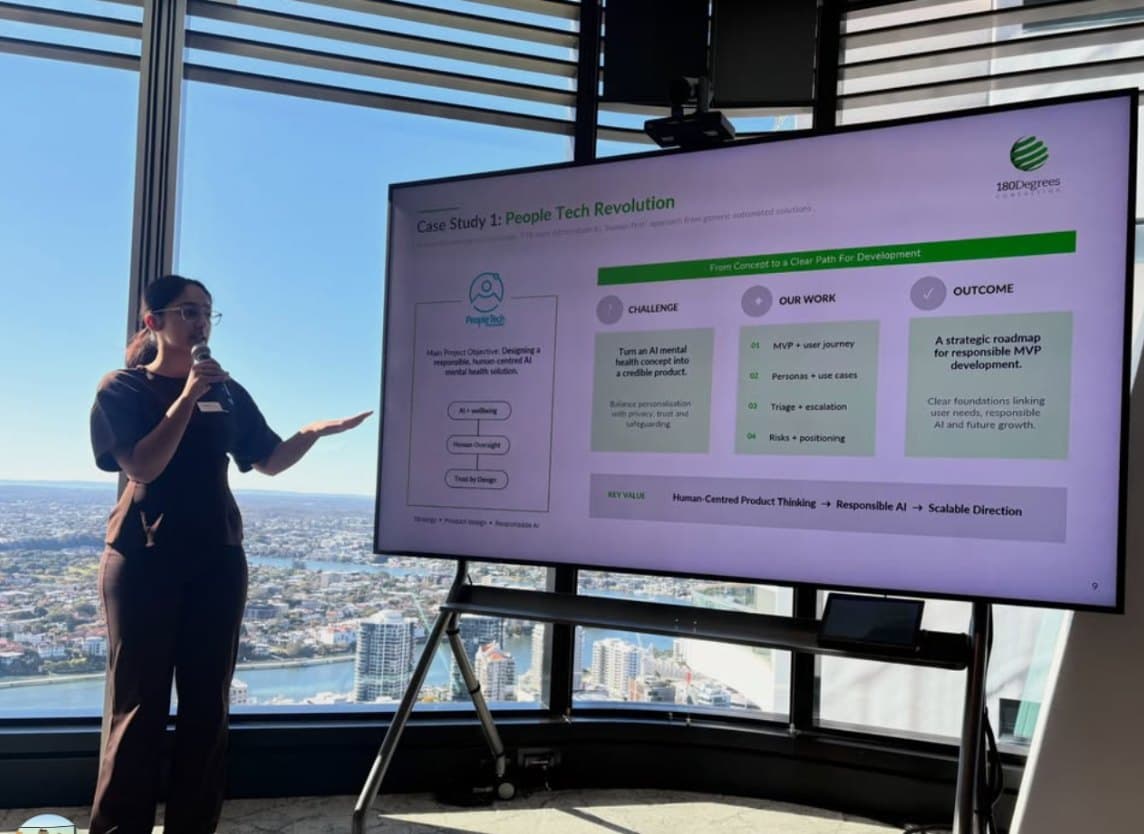 A consultant presenting a case study with the Brisbane skyline behind her