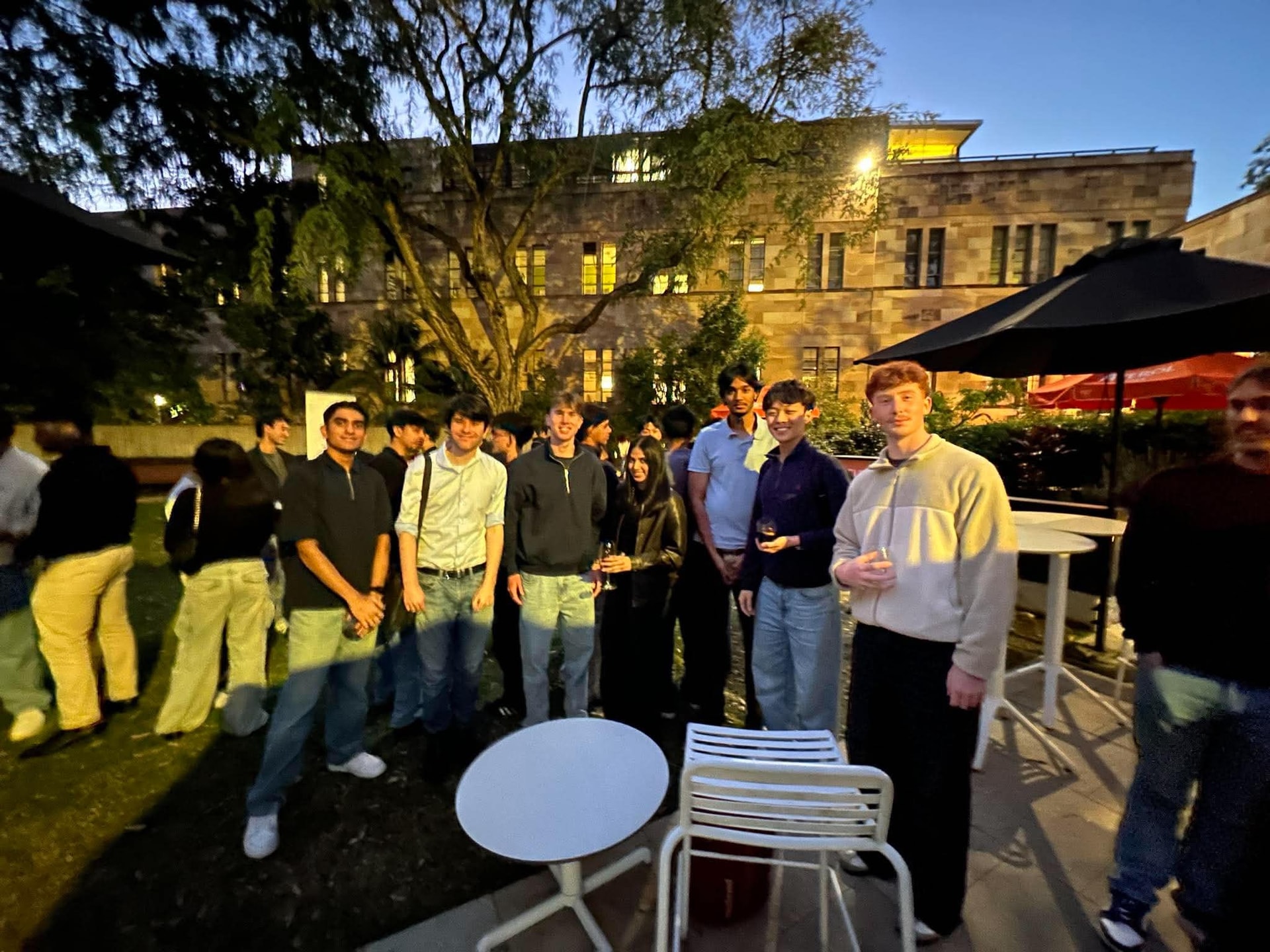 A group of 180DC UQ members at an evening event
